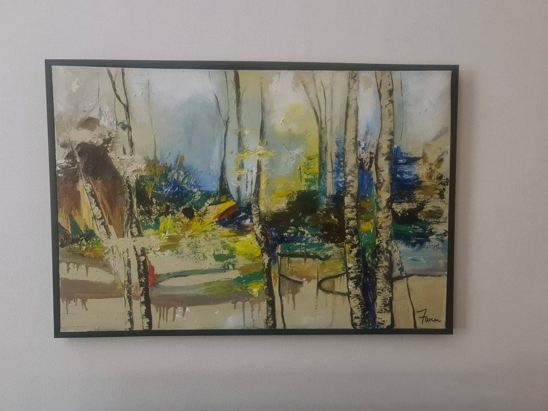 A framed, loosely painted woodland in pale greens, ochres and greys, the trunks left as bare vertical gaps in the colour.