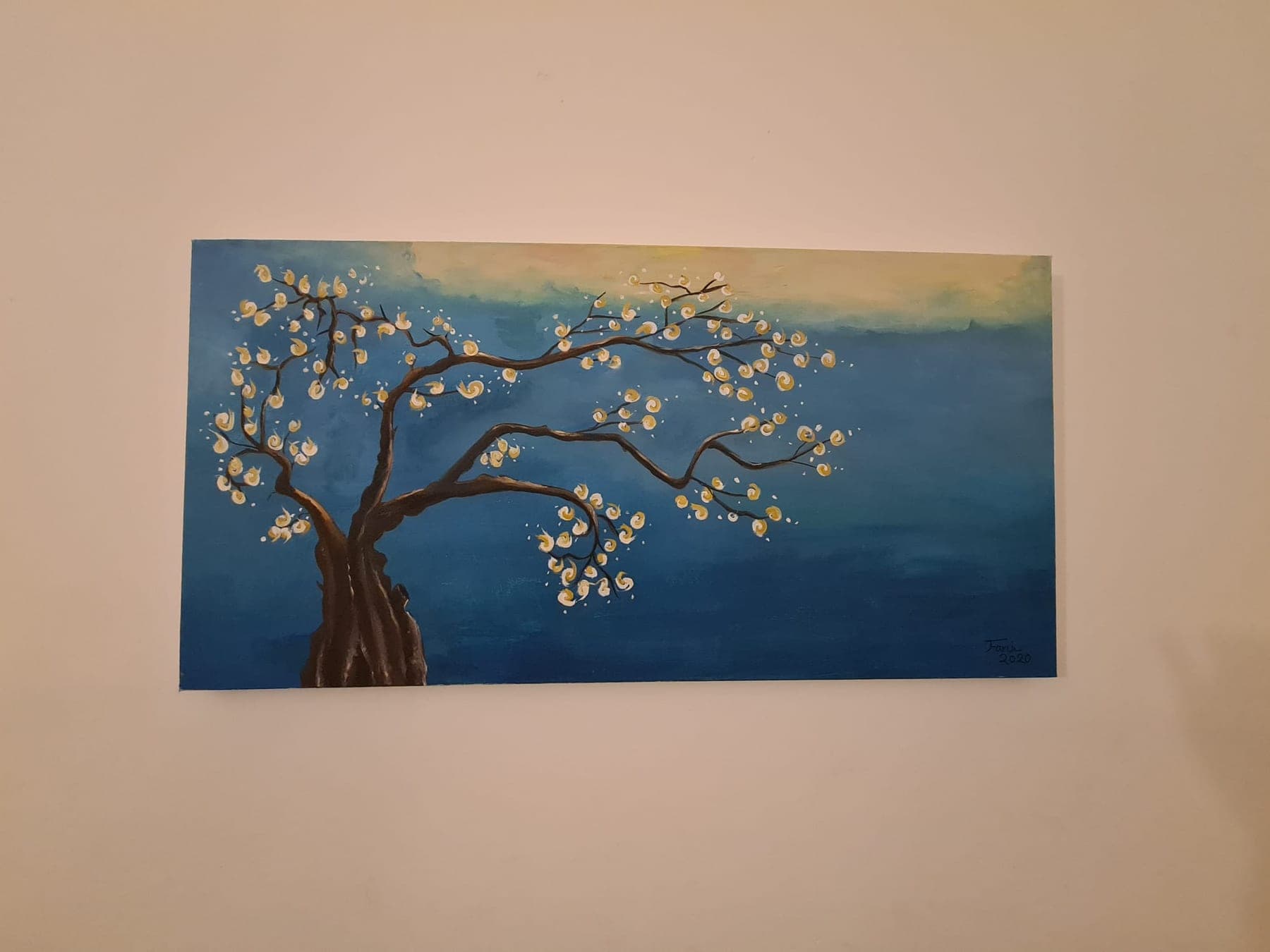 A wide landscape canvas of deep blue sea under a pale sky, with a dark twisting tree in white blossom leaning in from the left.