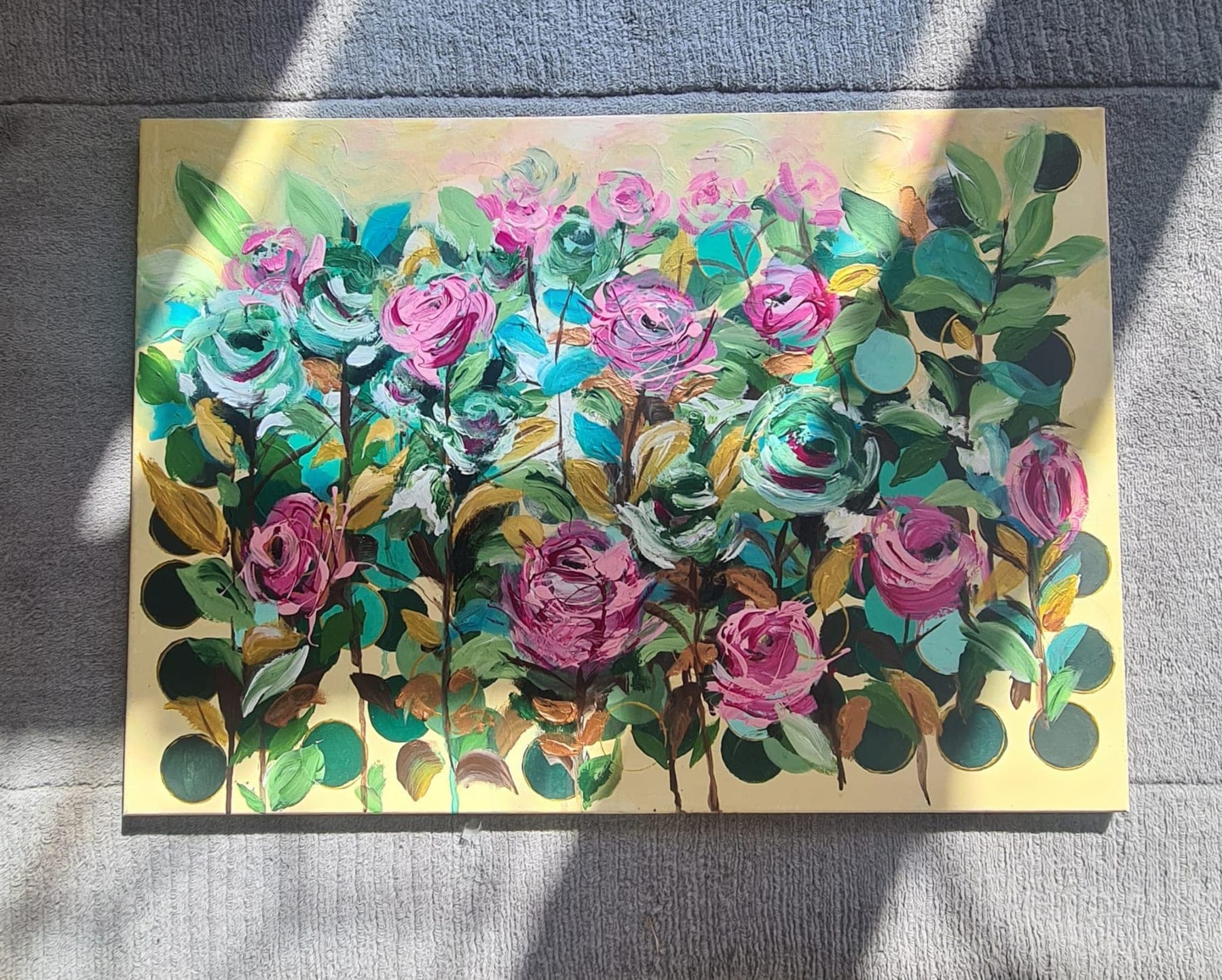 Rows of pink and magenta roses built up in thick relief on a pale gold ground, with sculpted green leaves between them, sunlight falling across the canvas.